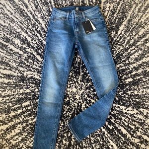 ASOS DESIGN spray on jeans in mid wash blue